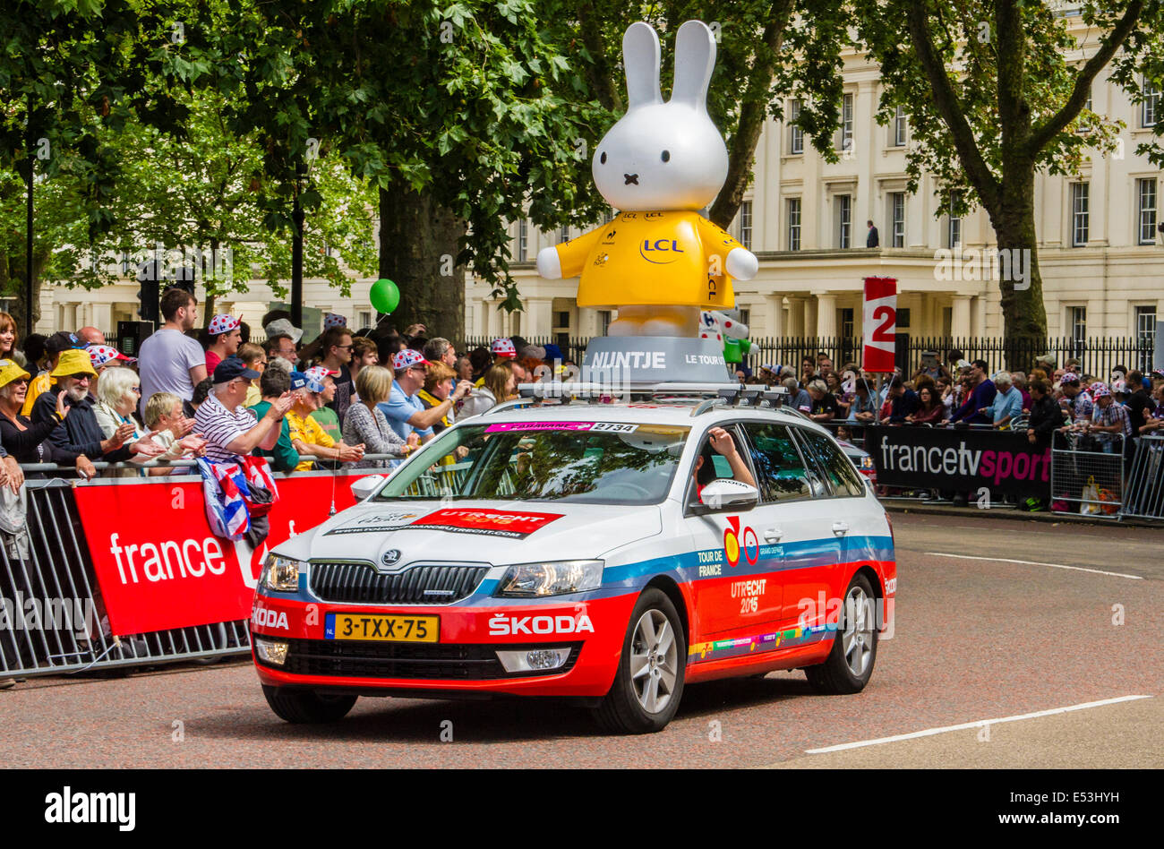 Sponsors' vehicles precede the arrival of the riders in the Tour De