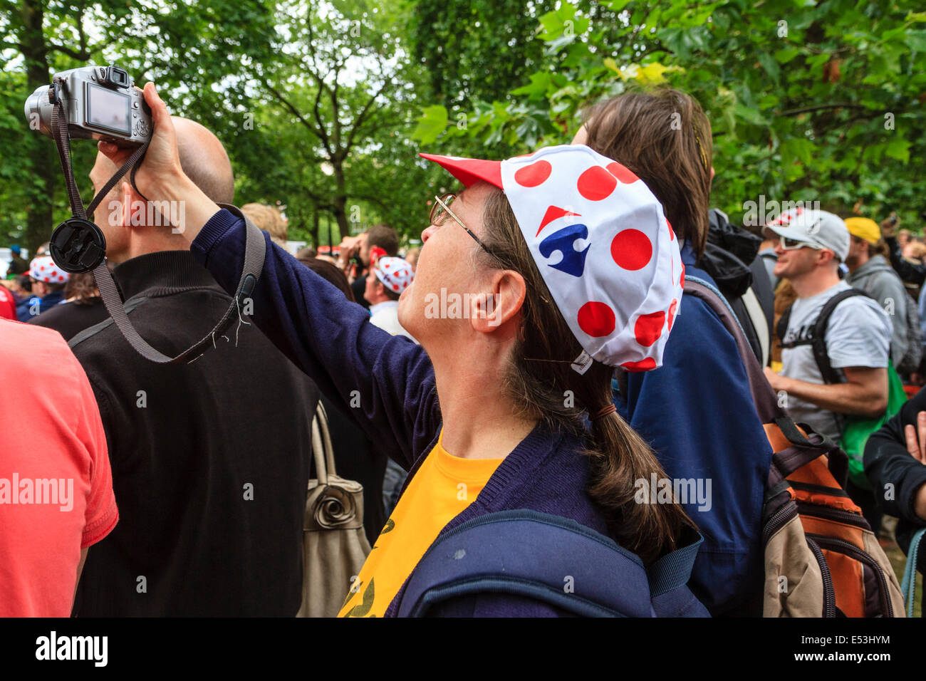 Spectator photographing action at the Tour De France 2014 third stage, London UK Stock Photo