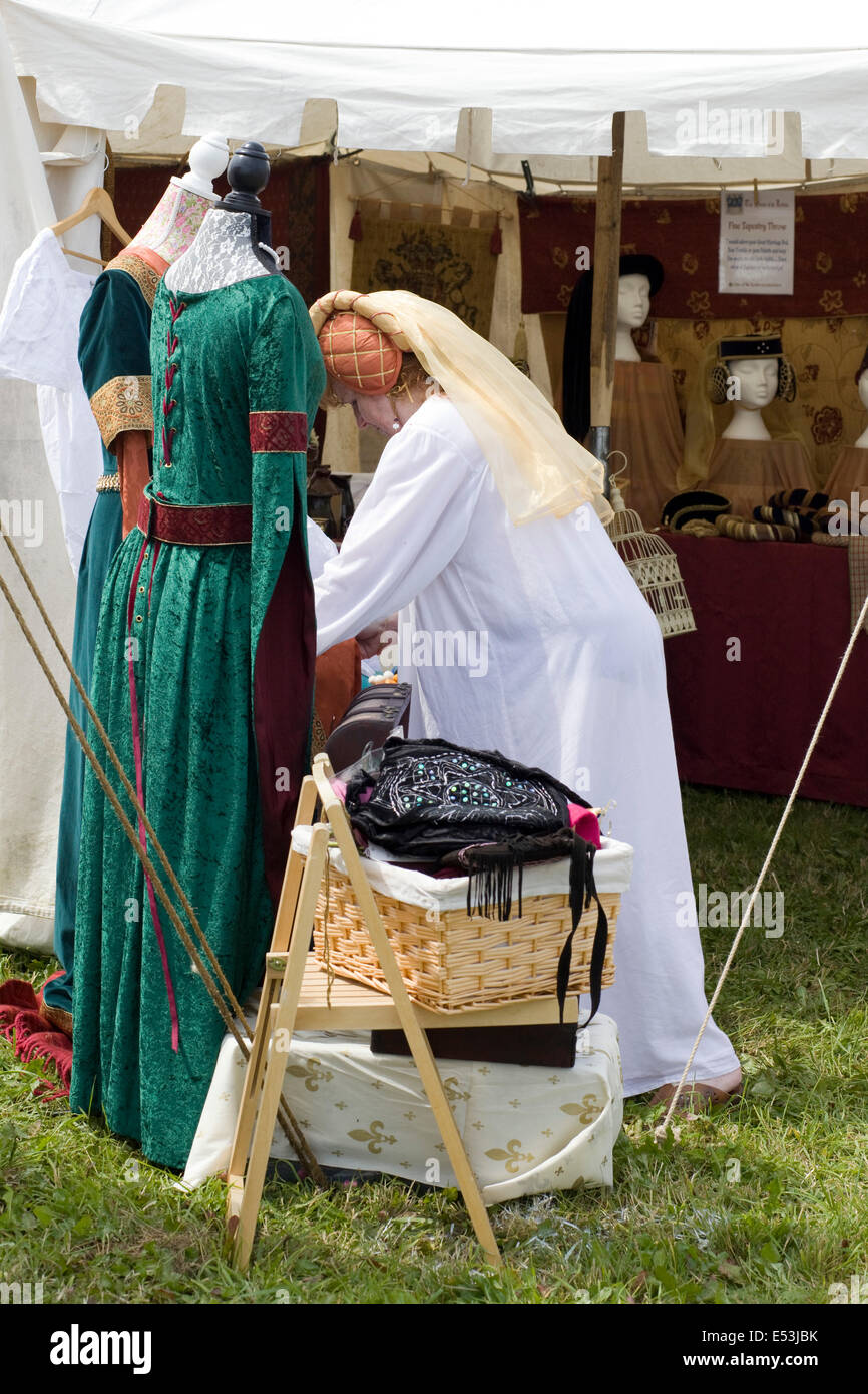 Lady in Medieval clothing on a market stall Stock Photo