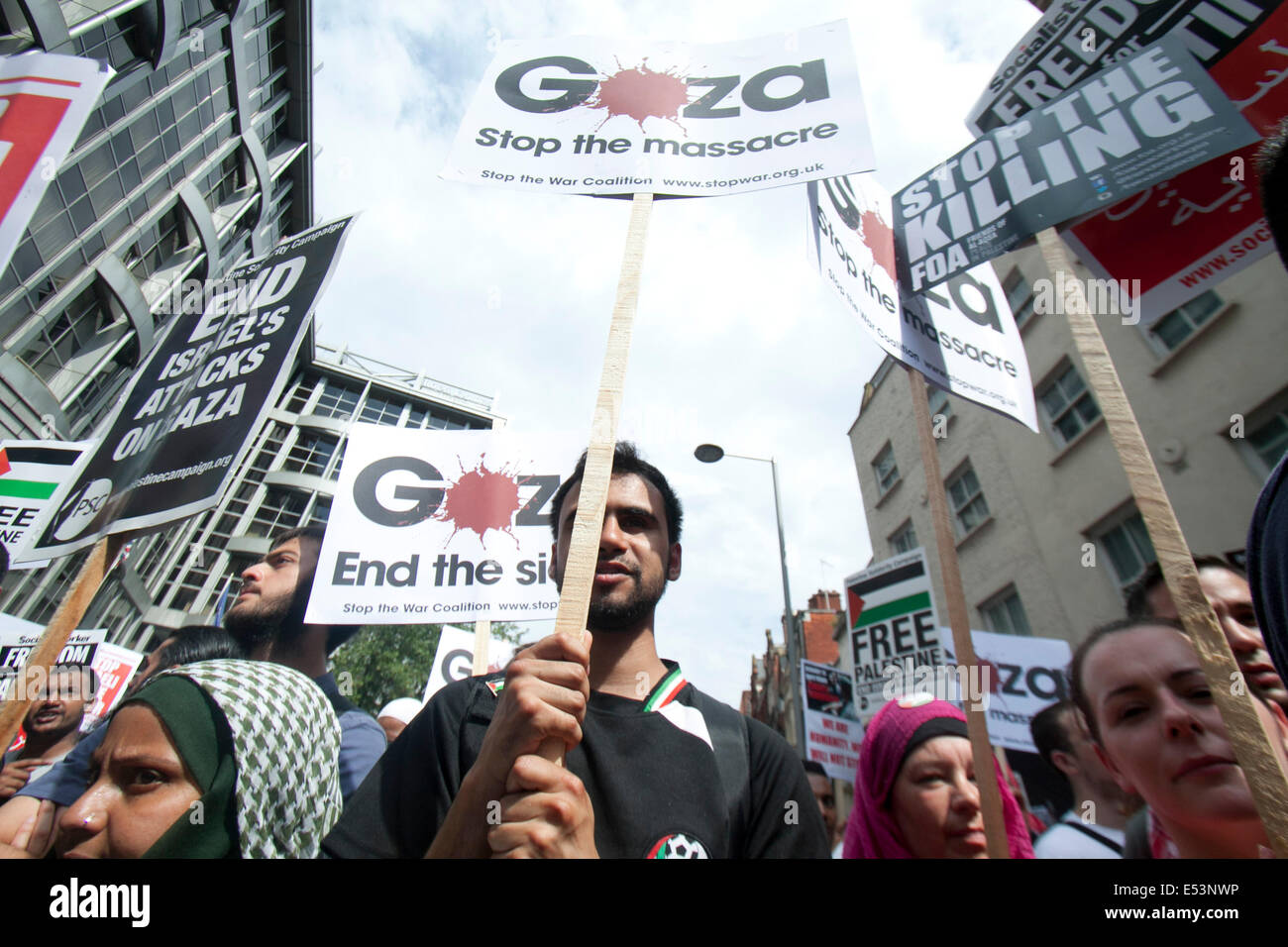 London UK. 19th July 2014.  Protesters hold placards  as thousands took part in a protest outside the Israeli embassy in London to show support for the Palestinian people and against Israeli military strikes in Gaza Credit:  amer ghazzal/Alamy Live News Stock Photo