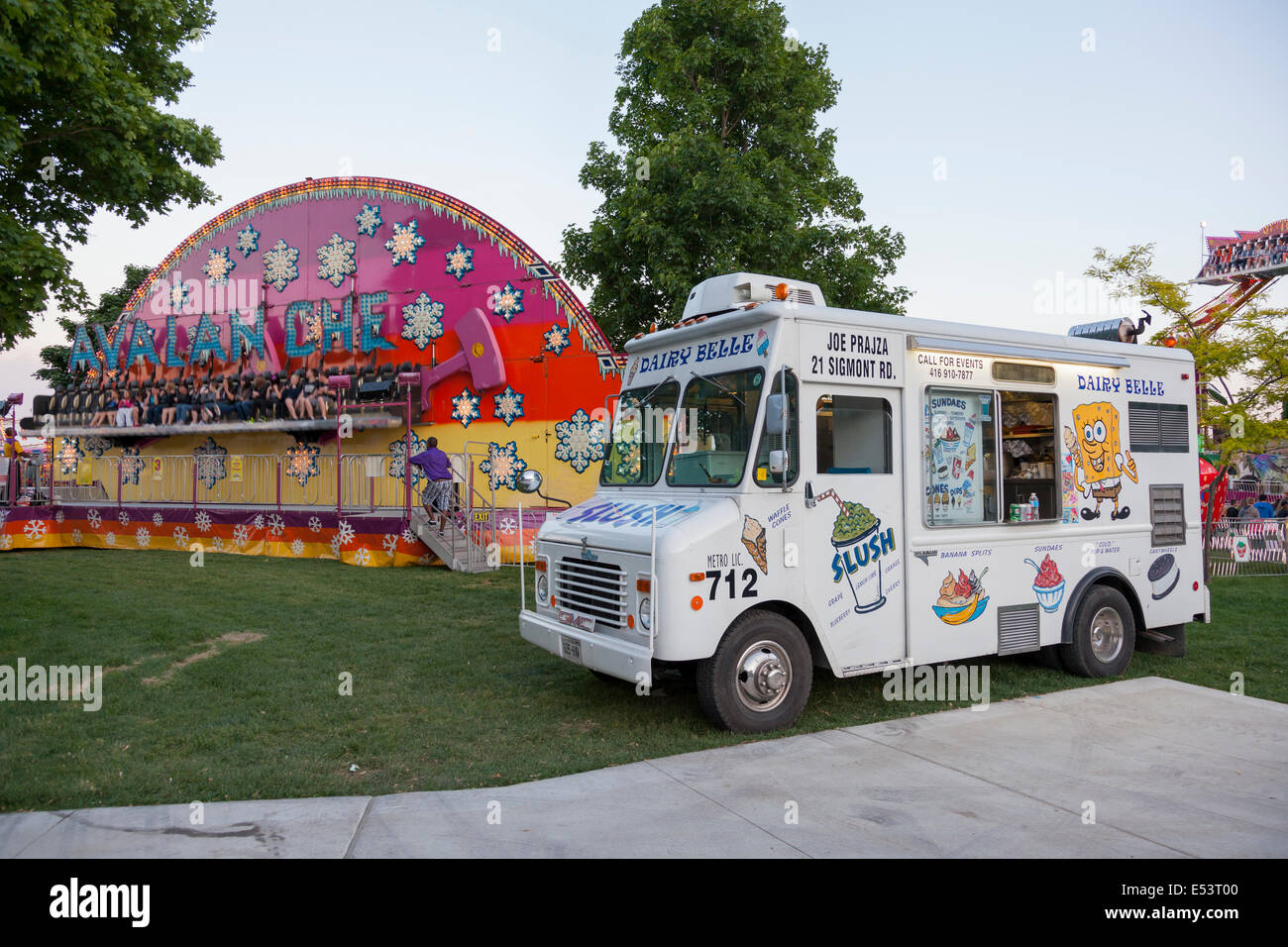 An Ice cream Truck and a carnival ride at the 'Sound of Music Festival' at Spencer Smith Park in Burlington, Ontario, Canada. Stock Photo