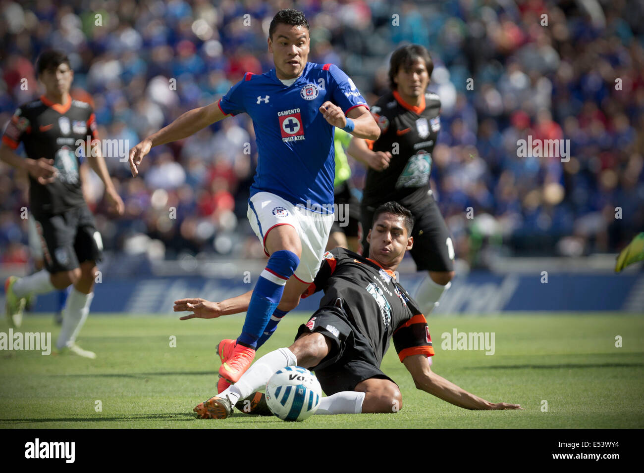 Mexico City, Mexico. 19th July, 2014. Cruz Azul's Pablo Barrera (front top) vies for the ball with Pachuca's Hugo Rodriguez during their match of the MX League Opening Tournament held at Azul Stadium in Mexico City, capital of Mexico, on July 19, 2014. Credit:  Alejandro Ayala/Xinhua/Alamy Live News Stock Photo