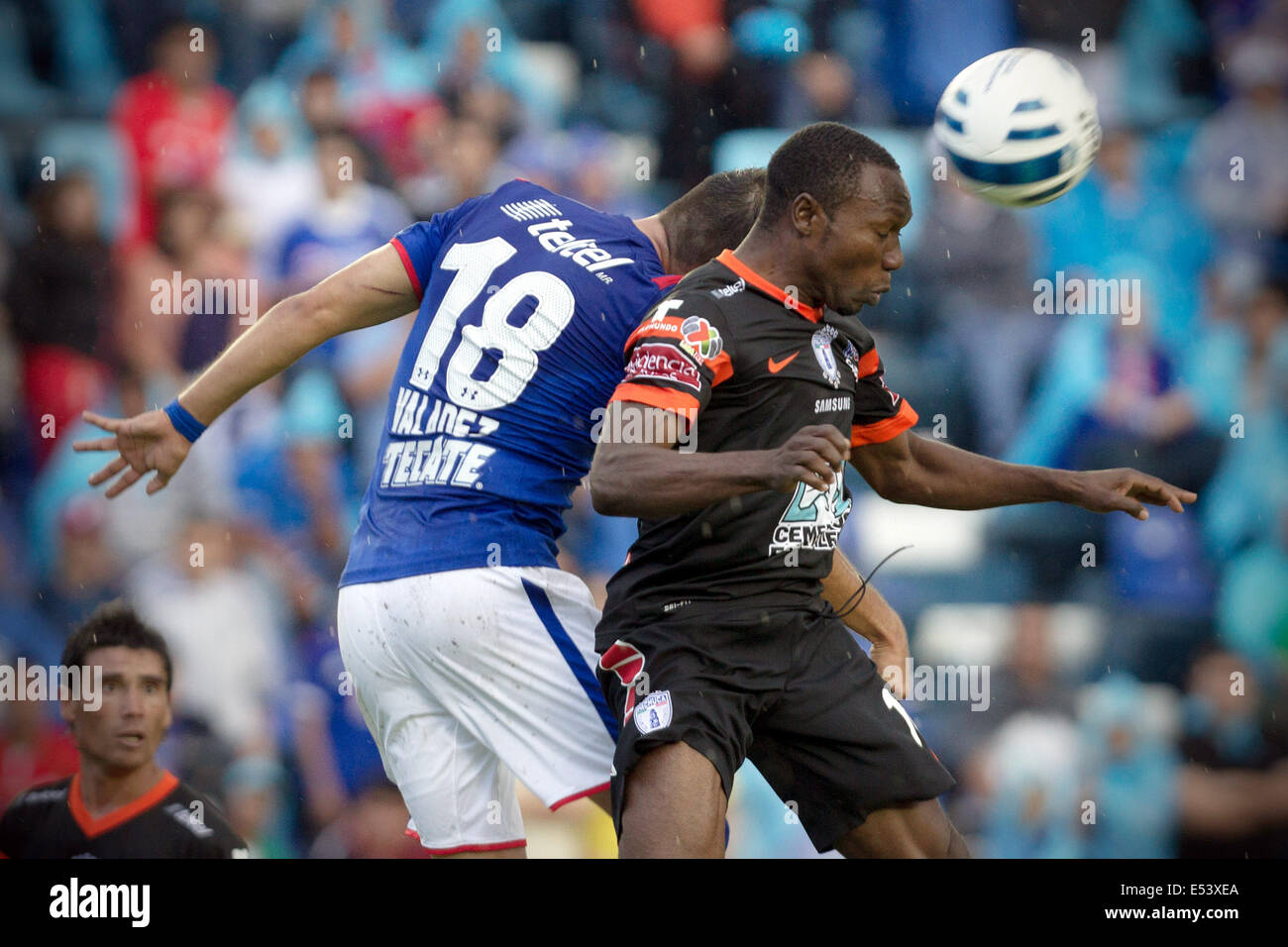 Mexico City, Mexico. 19th July, 2014. Cruz Azul's Ismael Valadez (L) vies for the ball with Walter Ayovi of Pachuca during the match of the MX League Opening Tournament held at Azul Stadium in Mexico City, capital of Mexico, on July 19, 2014. Credit:  Alejandro Ayala/Xinhua/Alamy Live News Stock Photo