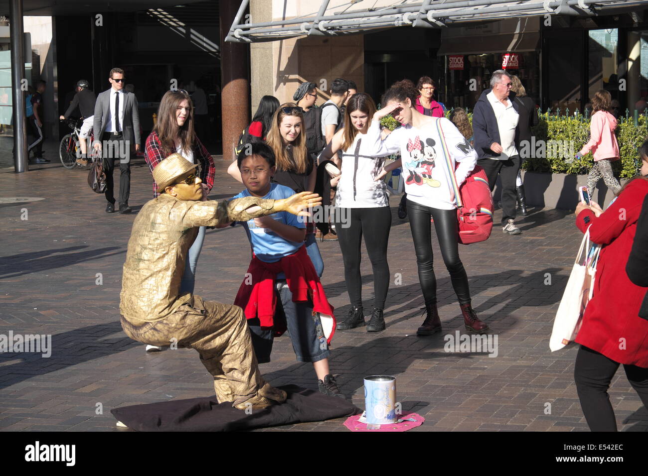 mime artist entertaining a young asian child at Circular Quayy,Sydney,australia Stock Photo