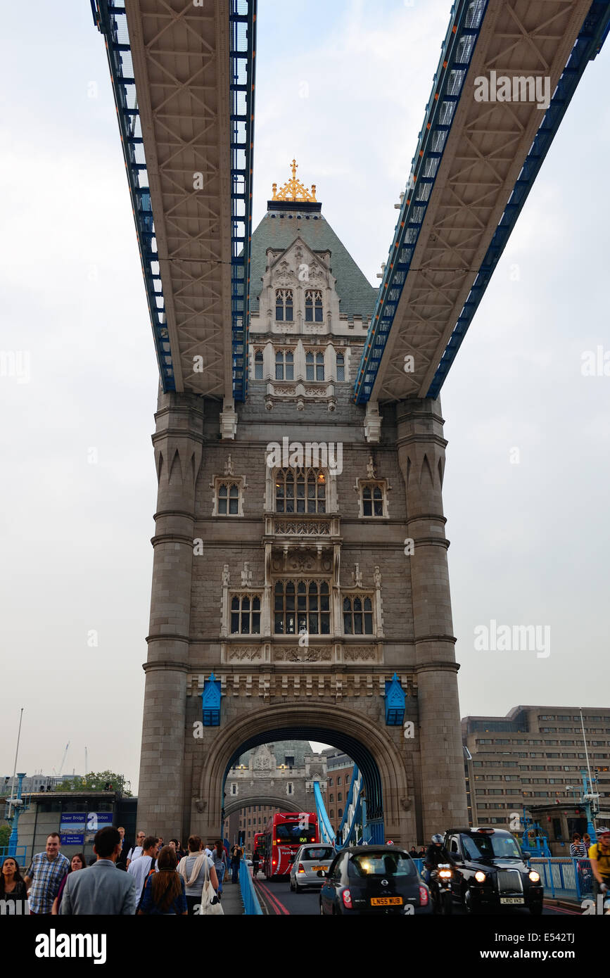 LONDON, UK - SEP 25: Tower Bridge with tourists and traffic on September 25, 2013 in London, UK. It is one of the iconic architectures in London and one of the most famous bridges in the world. Stock Photo