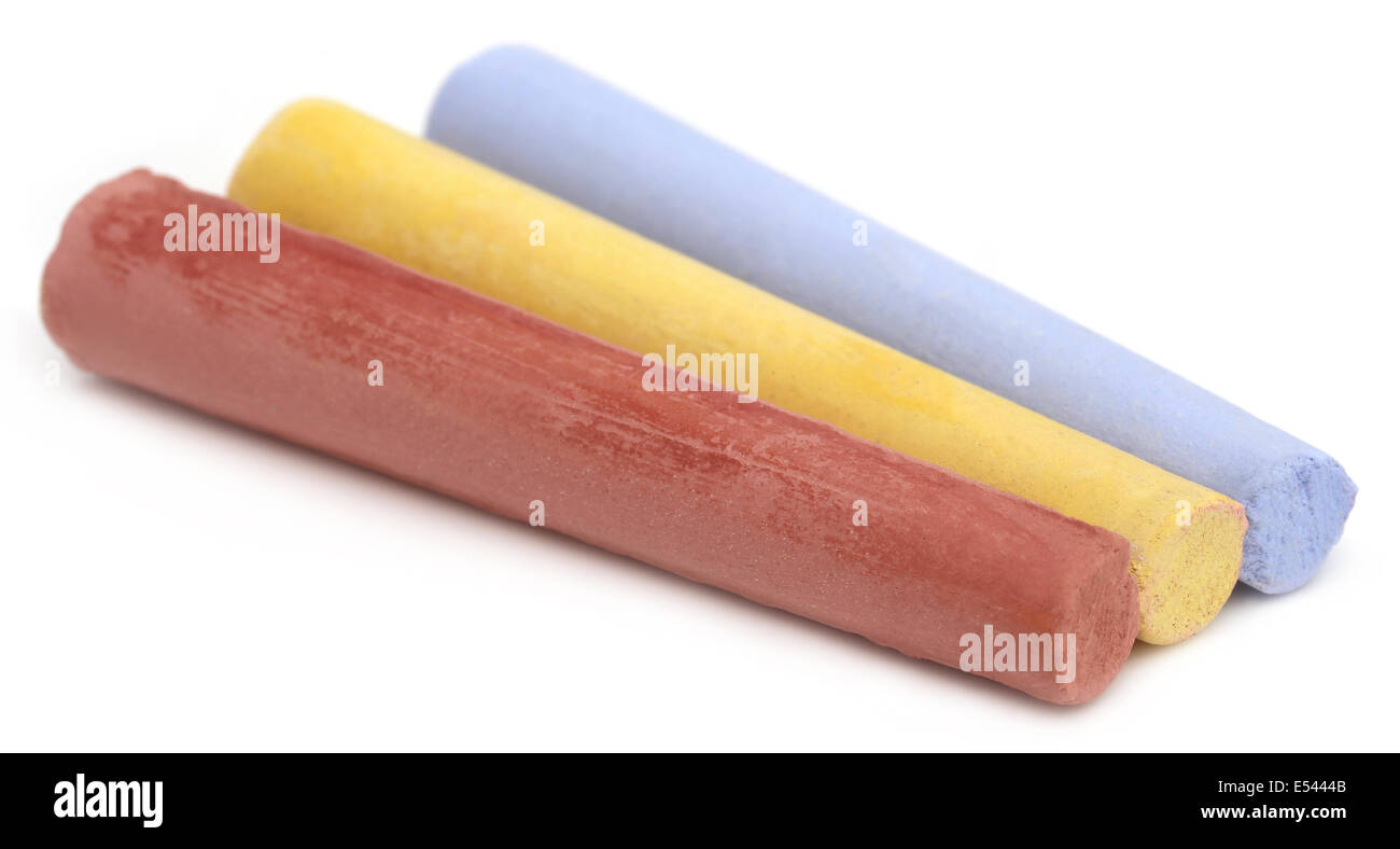 Three color chalks over white background Stock Photo