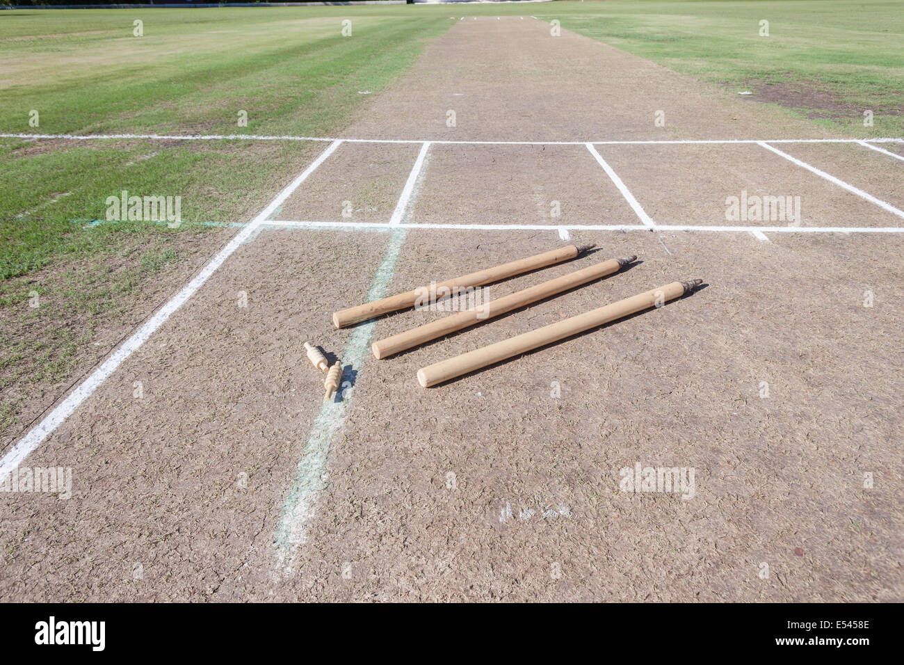 Cricket Pitch surface field wooden wickets and bails ready for game Stock Photo
