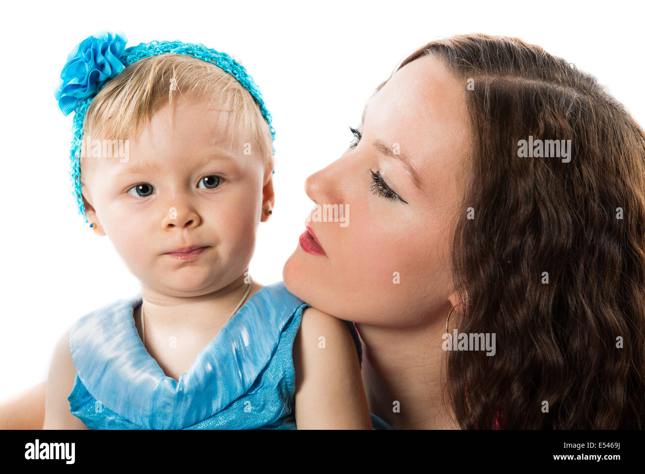 Happy mom and baby girl hugging on isolated white background Stock Photo