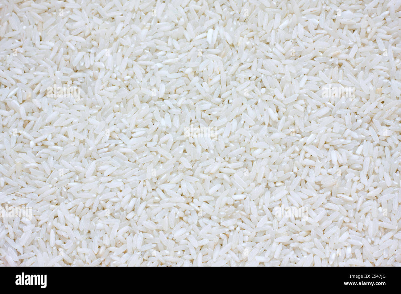 Uncooked white rice texture Stock Photo - Alamy