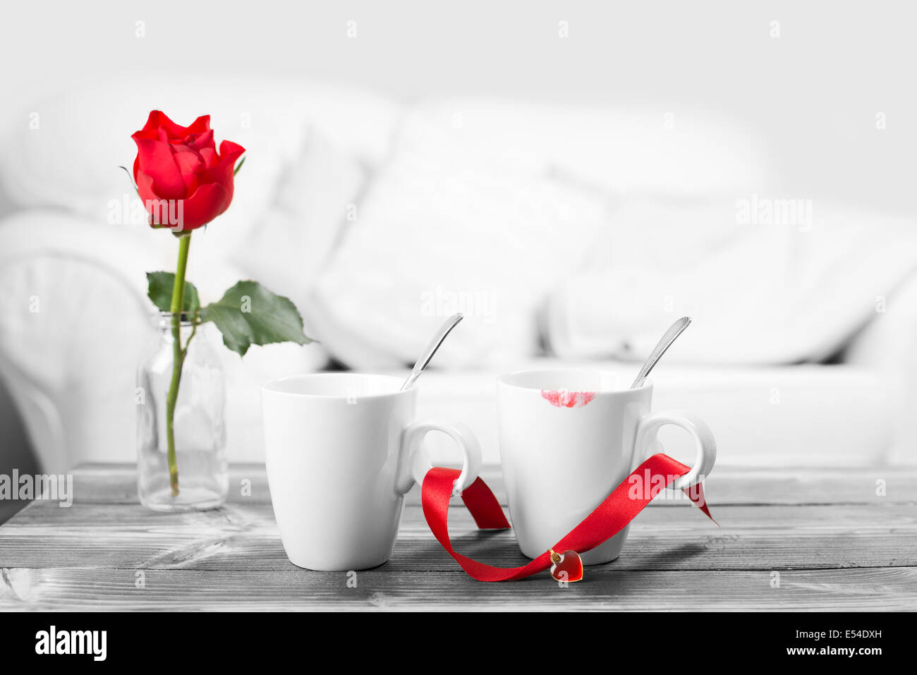 Red lipstick on coffee cups - black and white image with selective red color Stock Photo