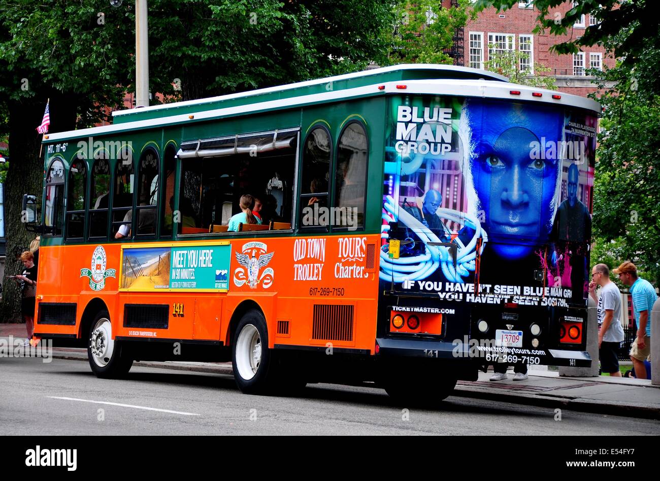 BOSTON, MASSACHUSETTS:  Old Town Trolley Bus stops to pick up passengers on Beacon Street Stock Photo