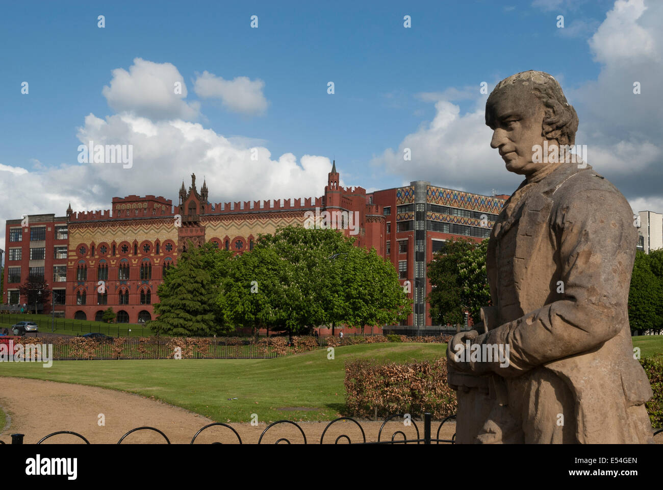James Watt Statue on Glasgow Green with the Templeton Business Centre in background.. Stock Photo