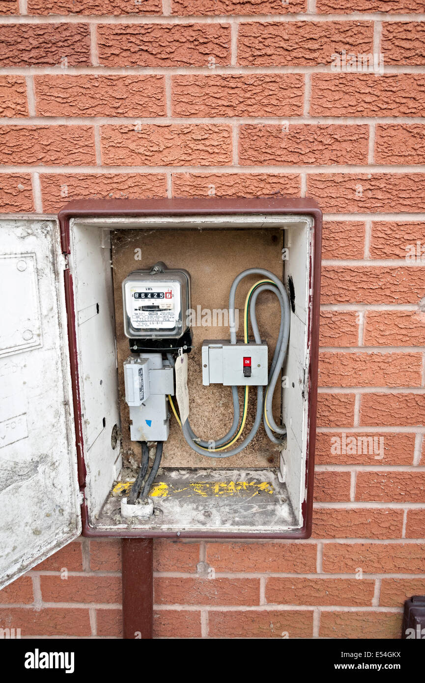 an electric meter on the external wall of a uk house Stock Photo - Alamy