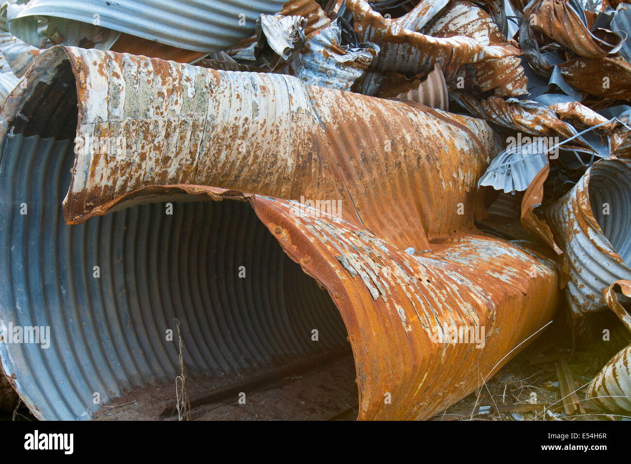 Scrap heap of rusting discarded drainage pipes Stock Photo