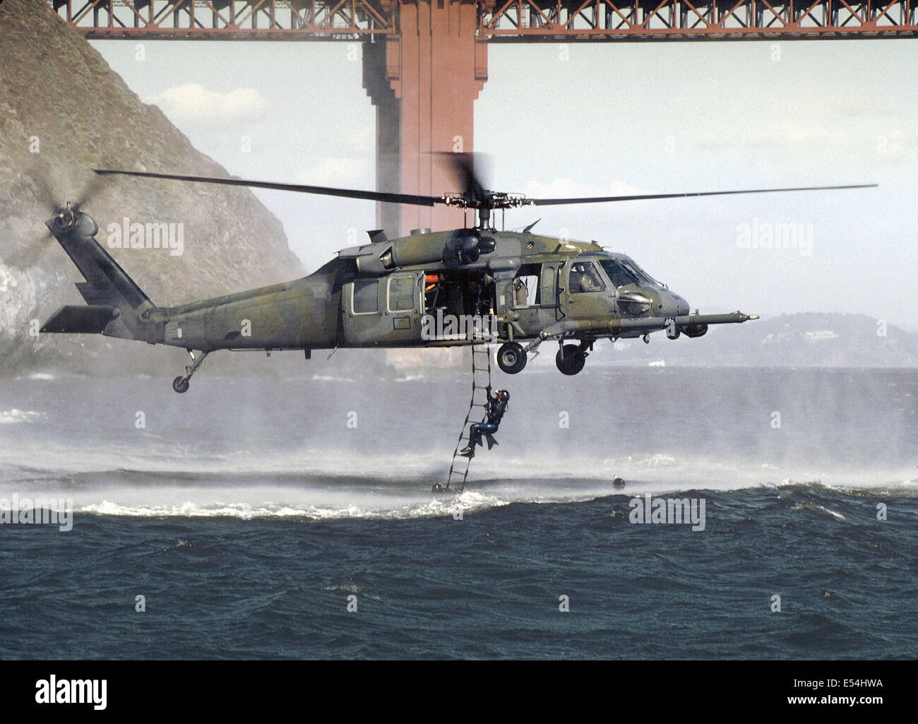 California Air National Guard pararescue soldiers with the 129th Rescue Wing climb into a HH-60G Pave Hawk helicopter using a rope ladder from the chilly waters near the Golden Gate Bridge July 14, 2000 in San Francisco, CA. Stock Photo