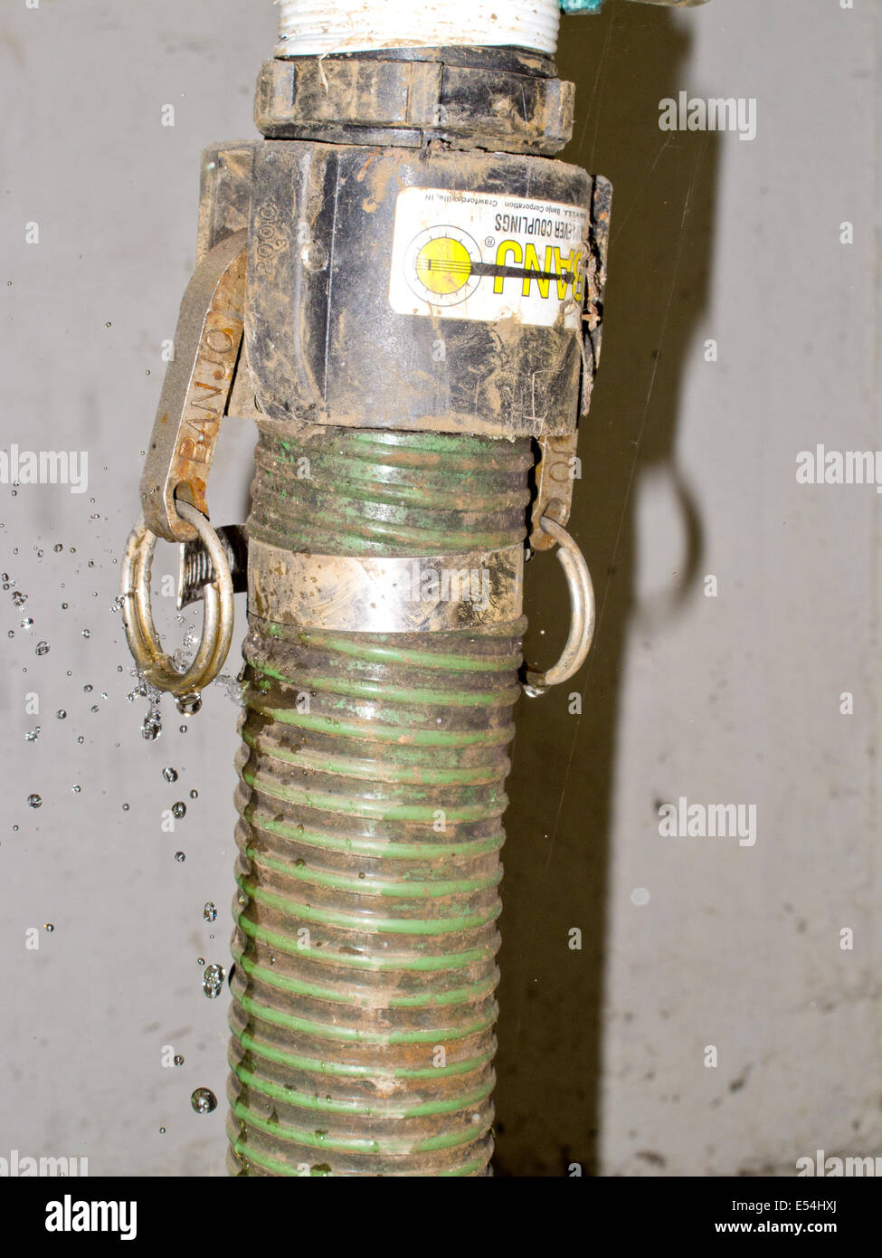 a view of a leaking pipe joint with water droplets showing Stock Photo