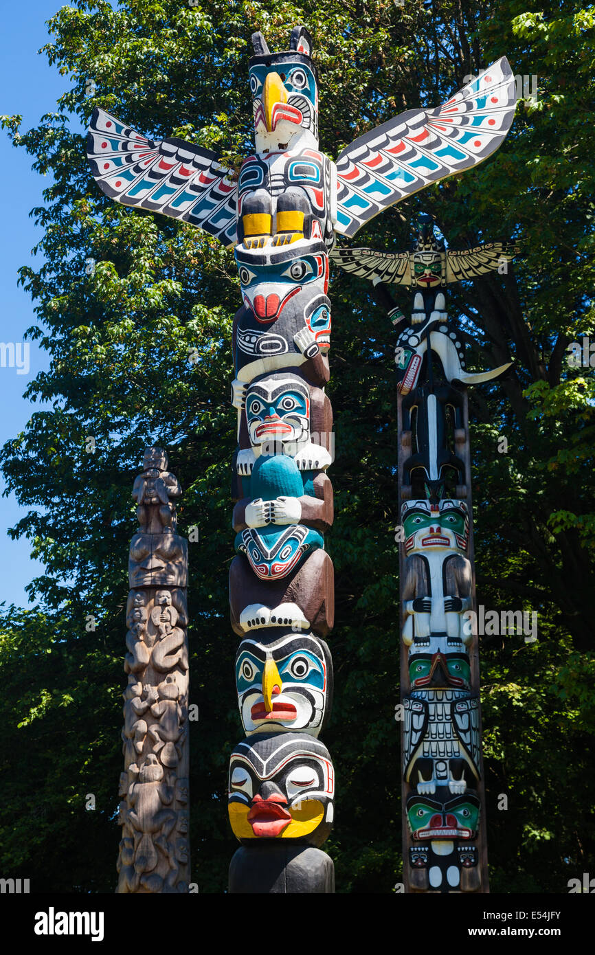 Group of three totem poles in Stanley Park, Vancouver Stock Photo