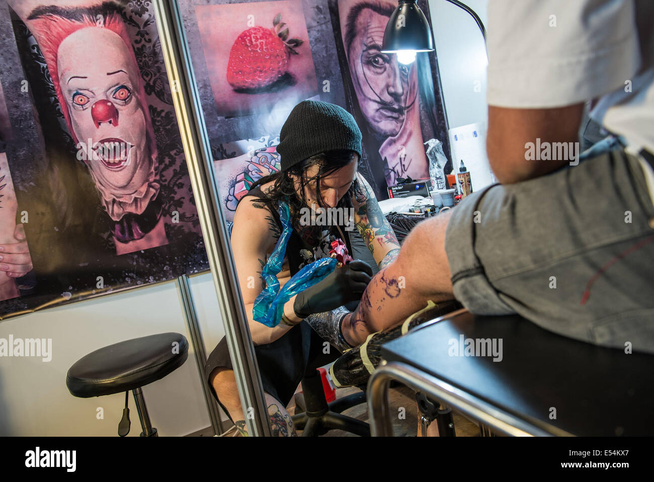 Gdansk, Poland. 20th July 2014. Tattoo artists works with his client during  the second day of Cropp Tattoo Konwent – sixth edition of tattoo convention  in Gdansk, Poland Credit: kpzfoto/Alamy Live News