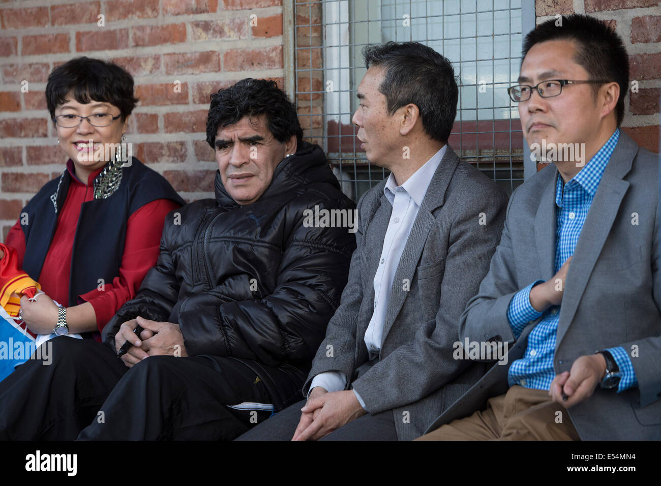 (140720) -- BUENOS AIRES, July 20, 2014 (Xinhua) -- The former player and coach of Argentina National Team, Diego Armando Maradona (2nd L), watches with the Cultural Counselor of the Chinese Embassy in Buenos Aires, Han Mengtang (2nd R) a training session in the sector 'Casa Amarilla' of Alberto J. Armando Stadium also known as 'La Bombonera', in the city of Buenos Aires, capital of Argentina, on July 20, 2014. The athletes belong to the first group of 60 players of the youth selection of Beijing as part of an agreement of sport association with the government of Beijing and the Athletic Club Stock Photo