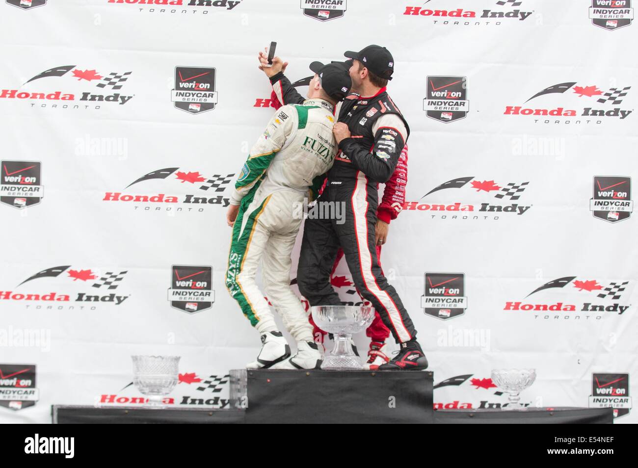 Toronto, Canada. 20th July, 2014. Ed Carpenter Racing's British driver Mike Conway (L) takes a selfie with Tony Kanaan (C) of Target Chip Ganassi Racing and Will Power of Team Penskecelebrates during the award ceremony of the race two of the 2014 Honda Indy Toronto of IndyCar Series race in Toronto, Canada, July 20, 2014. Ed Carpenter Racing's British driver Mike Conway won the race two title of the 2014 Honda Indy Toronto on Sunday. Credit:  Zou Zheng/Xinhua/Alamy Live News Stock Photo
