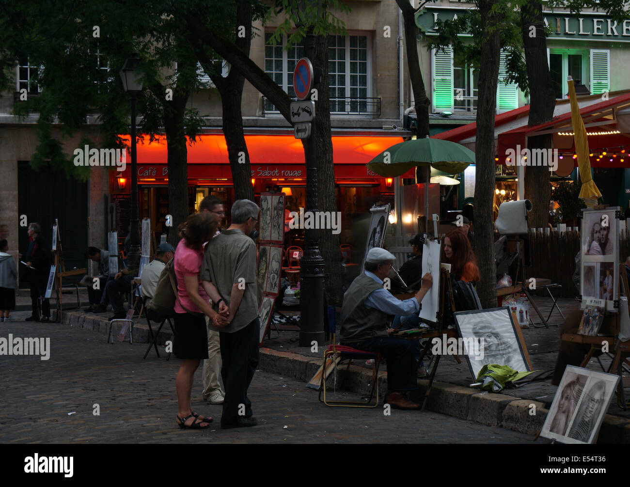 Street artists each setting up a drawing easel doing portraits for the tourists in the Place du Tertre square Paris France Stock Photo