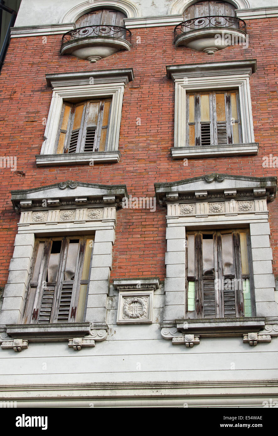 European old stately building with balconies and wooden fixtures completely ruined and destroyed Stock Photo