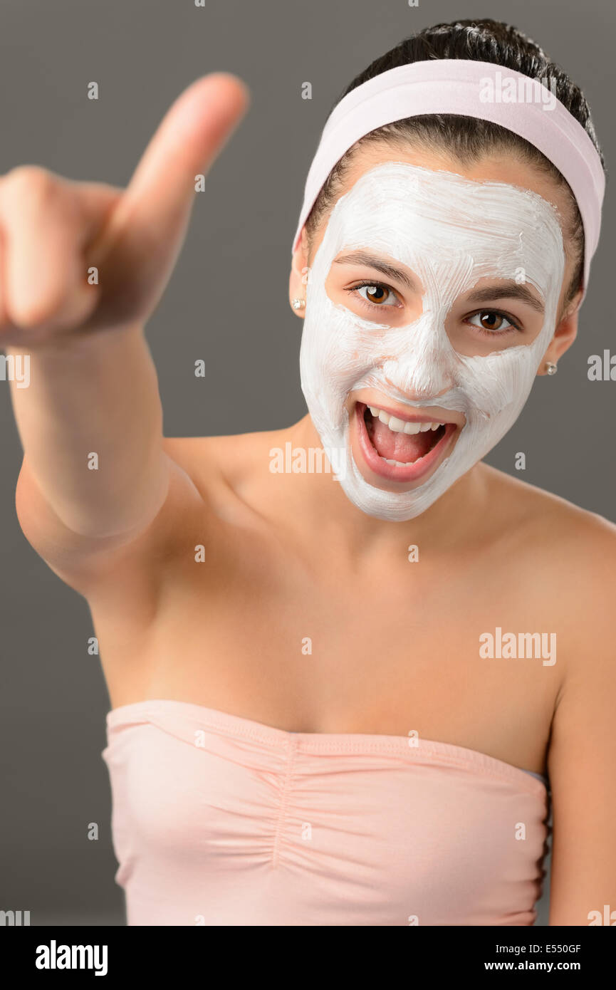 Teenage girl facial mask beauty thumb-up shouting on gray background Stock Photo