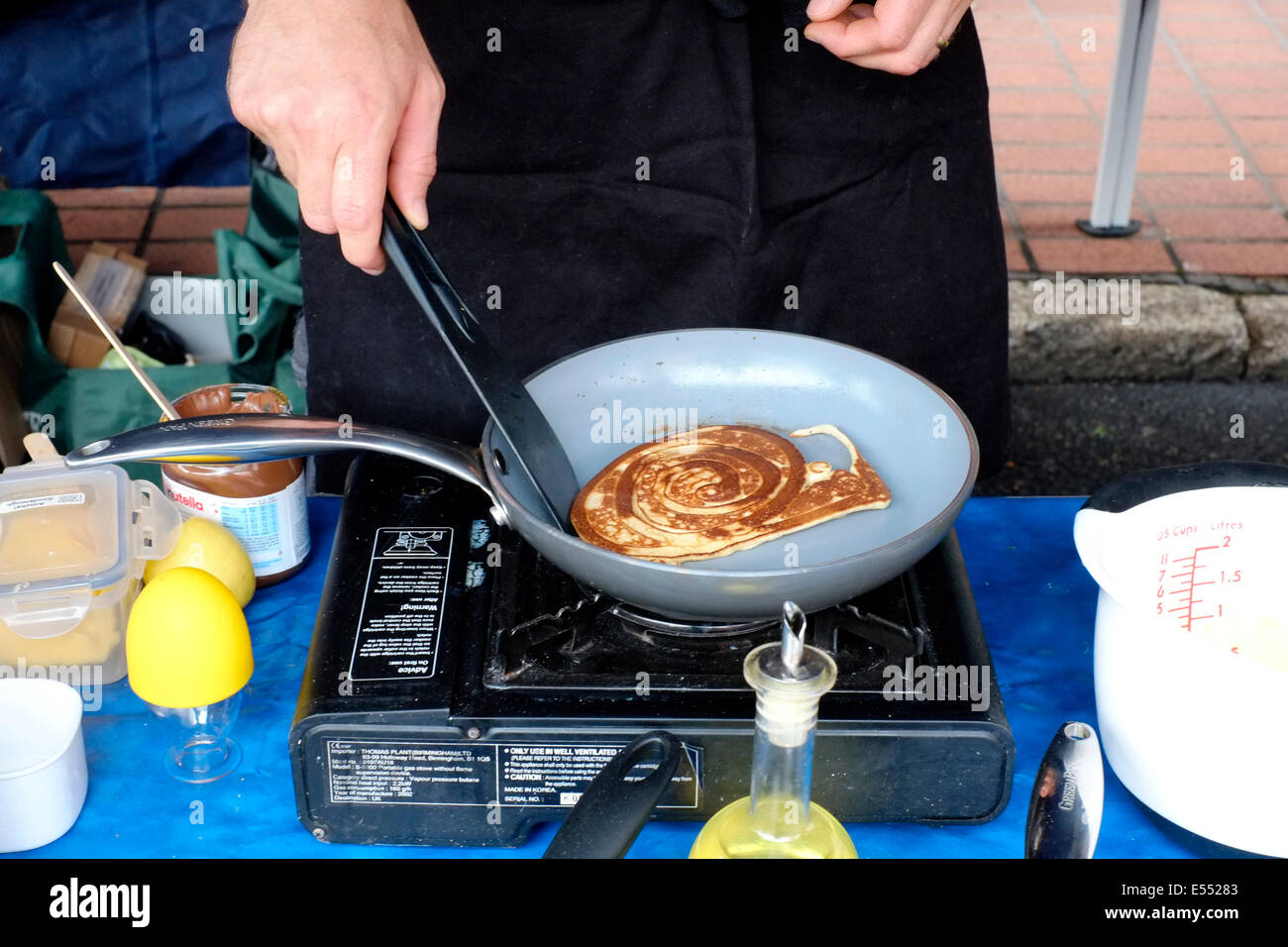 stall holder cooking a pancake at the southsea food fair festival 2014