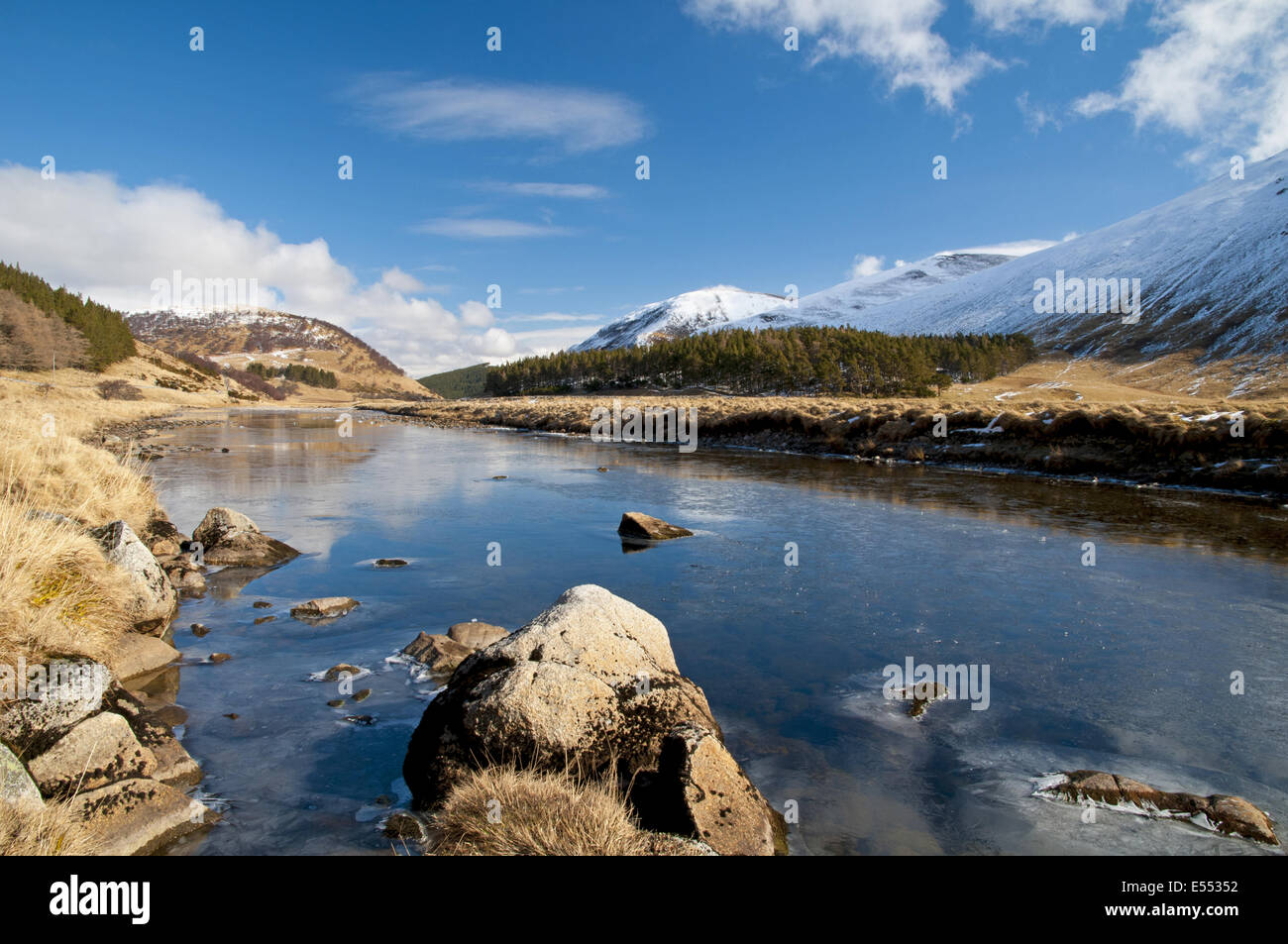 View of river flowing through valley with snow covered mountains, River ...