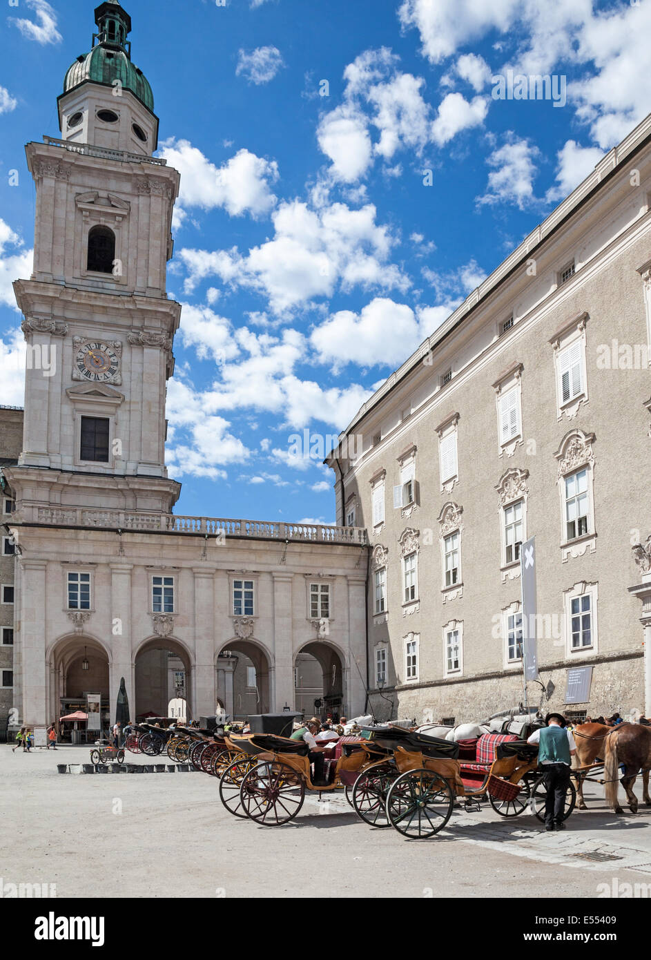 fiacres, a horse-drawn four-wheeled carriage, and their drivers waiting to be hired  Residenzplatz Salzburg Austria Europe Stock Photo
