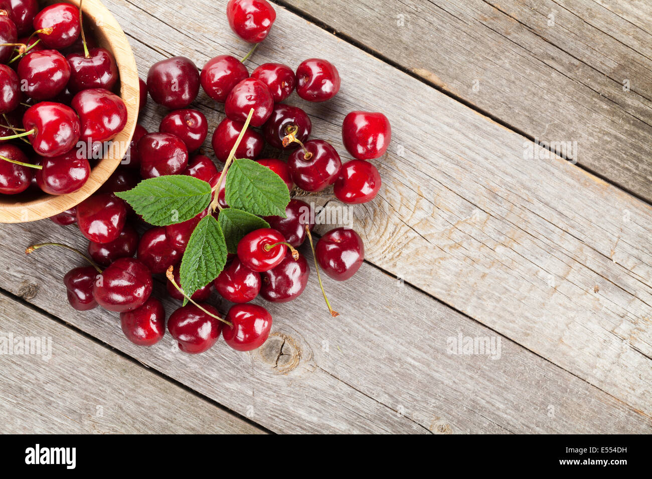 Ripe cherries on wooden table. View from above with copy space Stock ...