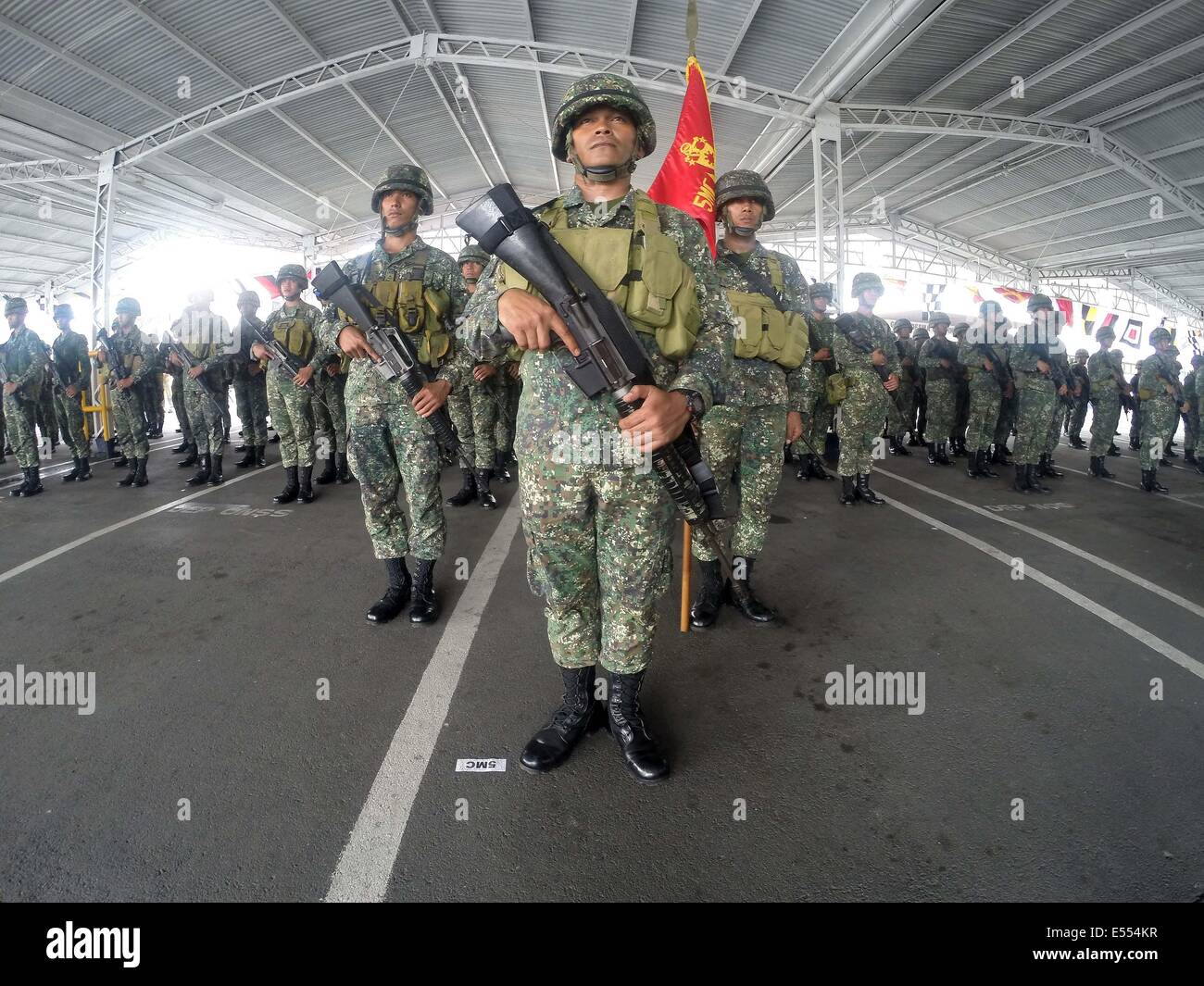 Manila, Philippines. 21st July, 2014. Members of the Marine Battalion Landing Team 5 (MBLT5) stand at attention during arrival ceremony inside the Philippine Navy Headquarters in Manila, the Philippines, July 21, 2014. More than 200 members of the MBLT5 arrived in Manila after serving almost 10 years in Northern Philippines. Credit:  Rouelle Umali/Xinhua/Alamy Live News Stock Photo