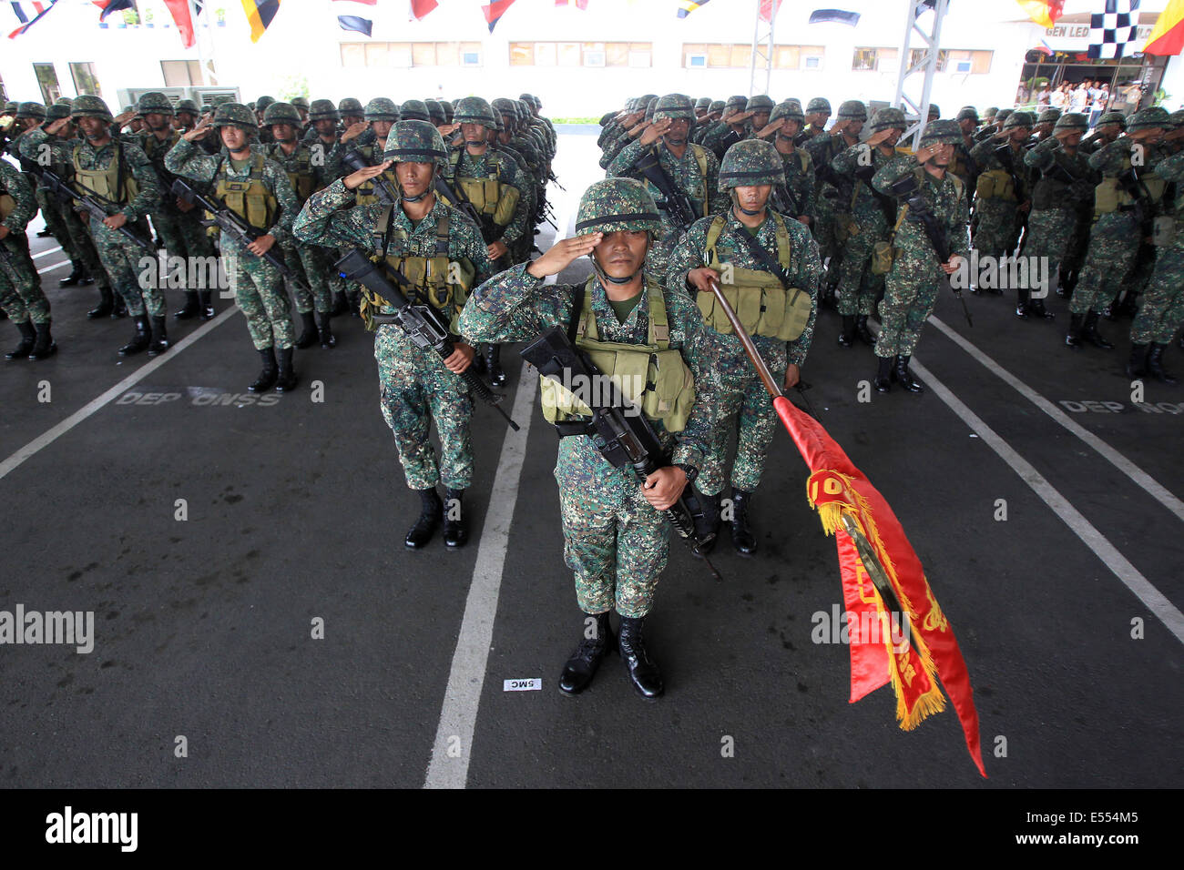 Manila, Philippines. 21st July, 2014. Members of the Marine Battalion Landing Team 5 (MBLT5) salute during arrival ceremony inside the Philippine Navy Headquarters in Manila, the Philippines, July 21, 2014. More than 200 members of the MBLT5 arrived in Manila after serving almost 10 years in Northern Philippines. Credit:  Rouelle Umali/Xinhua/Alamy Live News Stock Photo