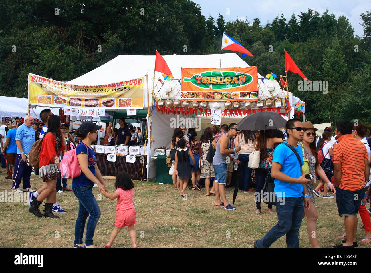 Walton, Surrey, UK. 20th July, 2014. More people queing for philippine food as a must to celebrate the cultural gathering, you must eat when attending a fiesta it is derisory not to. Here you can see British and Filipino's mingling together in celebration. Credit:  Paul Hamilton/Alamy Live News Stock Photo