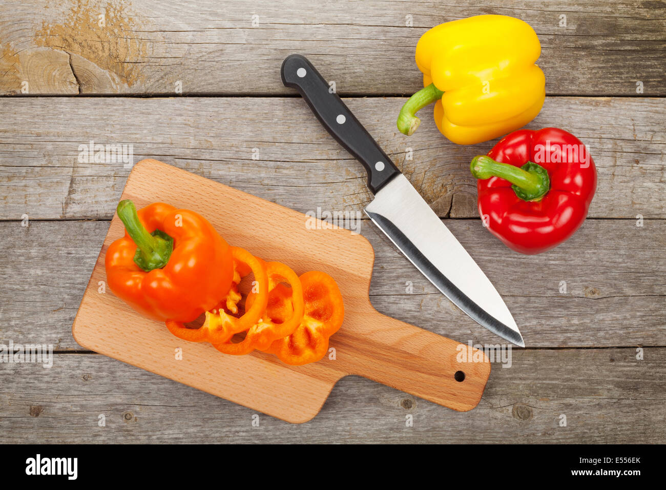Sliced bell pepper on cutting board over wooden table Stock Photo - Alamy