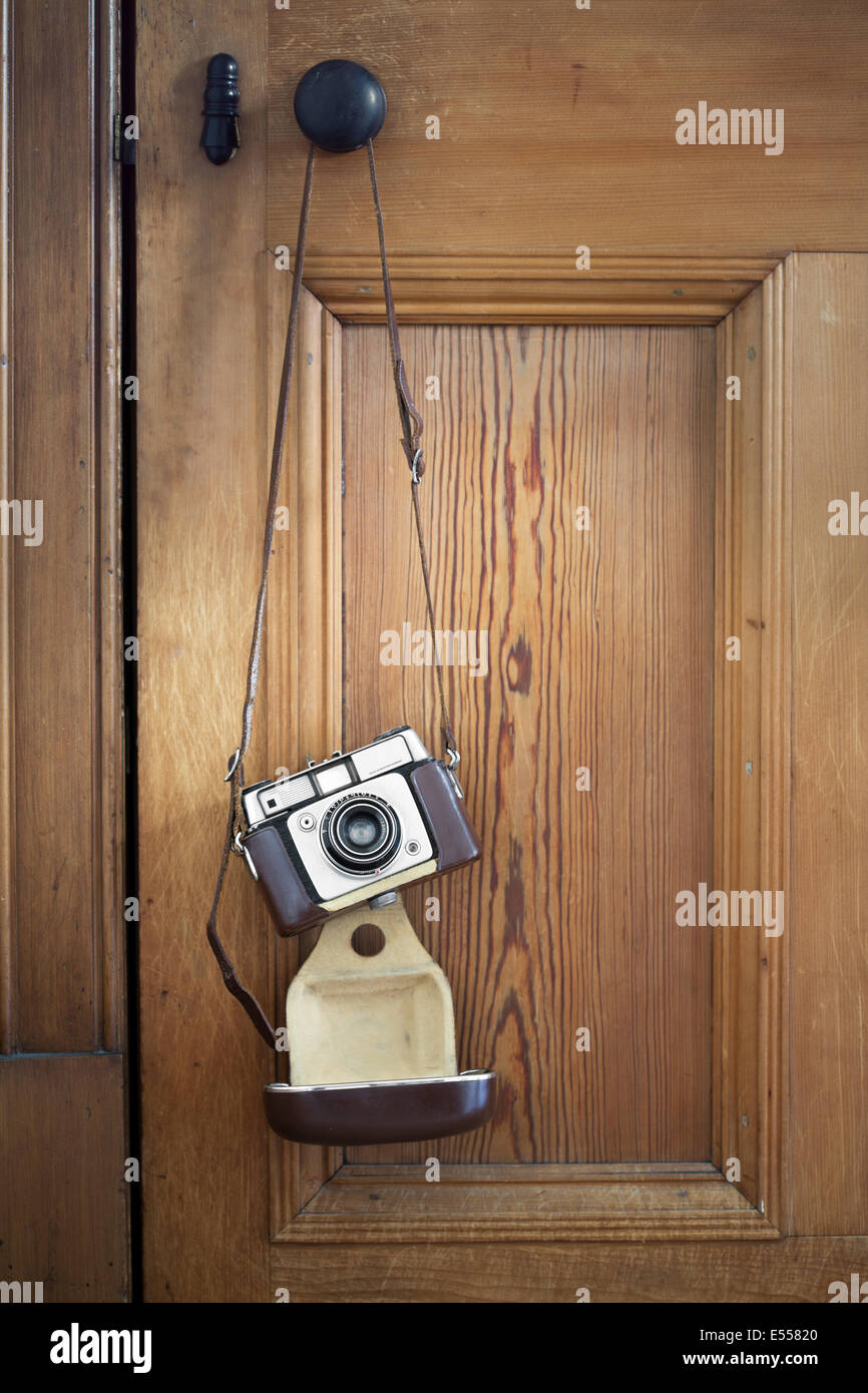 Vintage camera hanging on a door Stock Photo