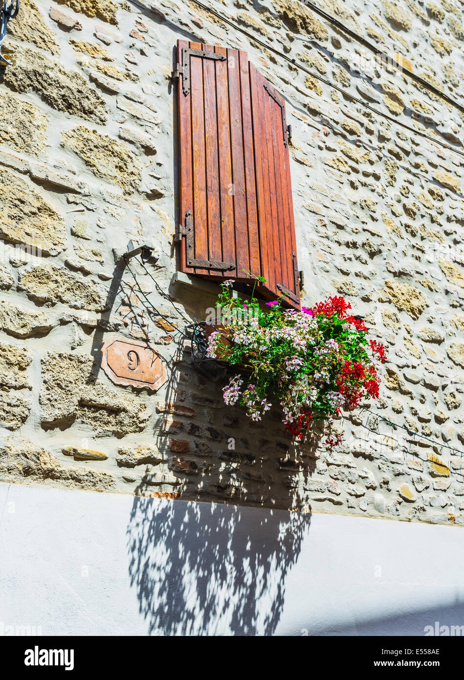 Window in an old house decorated with flower pots and flowers Stock ...