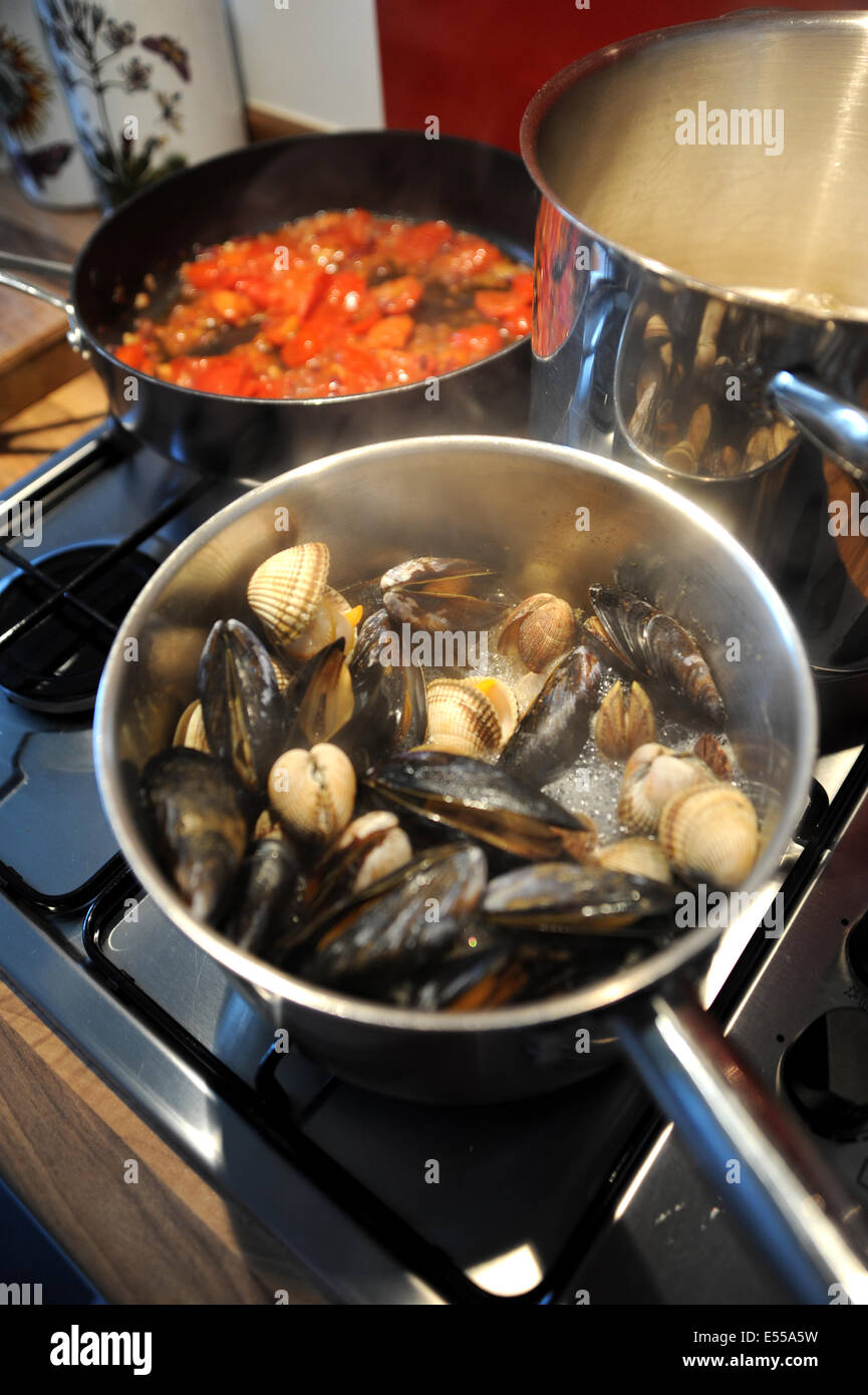 Seafood of mussels clams prawns and cockles with linguine pasta cooking
