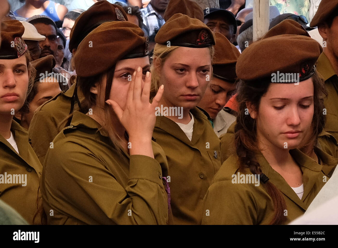 Mount Herzl Military Cemetery, Jerusalem, Israel. 21st July, 2014. Golani Brigade soldiers, with the unit's typical brown berets, mourn the loss of Moshe Malko. Staff Sergeant Moshe Malko, 20, was brought to rest at the Mount Herzl Military Cemetery. Malko, of the IDF Golani Brigade, is one of 13 IDF soldiers killed in combat in the Sugaiya Hamas stronghold in the Gaza Strip. Credit:  Nir Alon/Alamy Live News Stock Photo