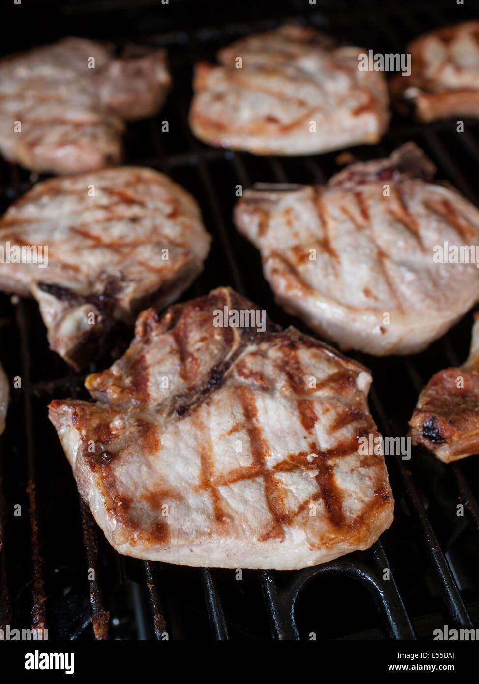 Pork Chops cooking on a grill Stock Photo Alamy