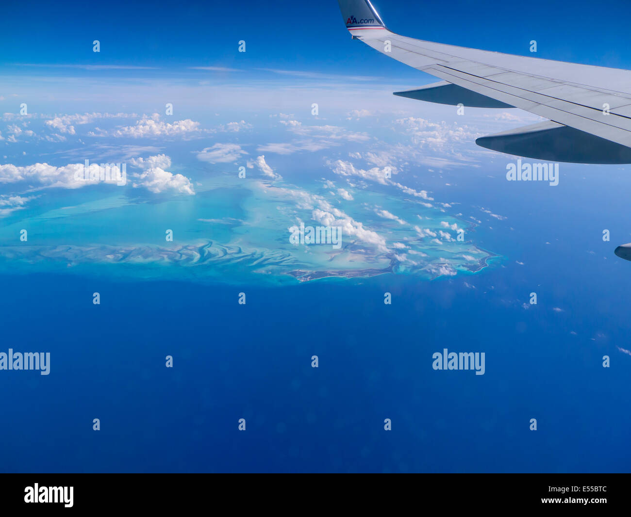 Abstract aerial view of Caribbean Sea with airplane wing in frame Stock Photo