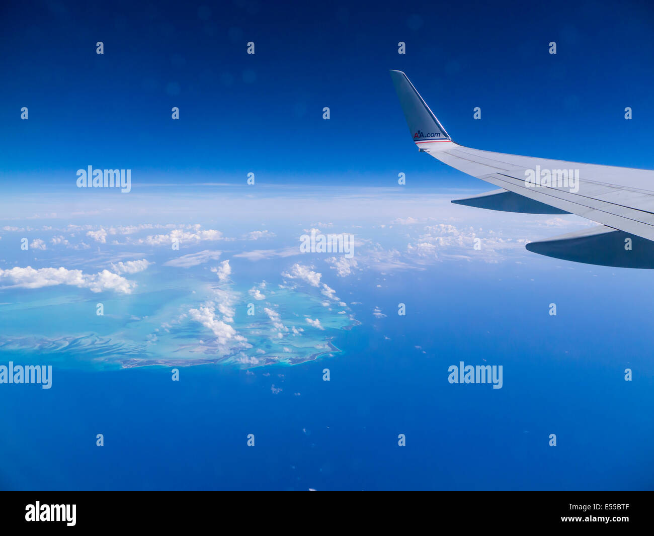 Abstract aerial view of Caribbean Sea with airplane wing in frame Stock Photo