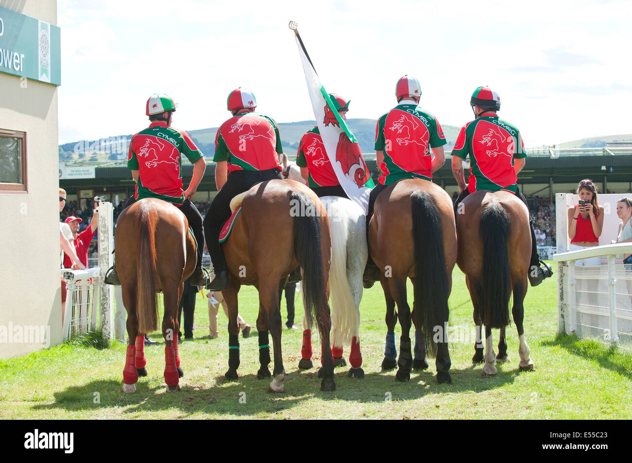 Llanelwedd, UK. 21st July 2014. Team Wales make their way to the Main Ring for The Royal Welsh Mounted Games. A record numbers of visitors in excess of 240,000 are expected this week over the four day period of Europe’s largest agricultural show. Livestock classes and special awards have attracted 8,000 plus entries, 670 more than last year. The first ever Royal Welsh Show was at Aberystwyth in 1904 and attracted 442 livestock entries. Credit:  Graham M. Lawrence/Alamy Live News. Stock Photo