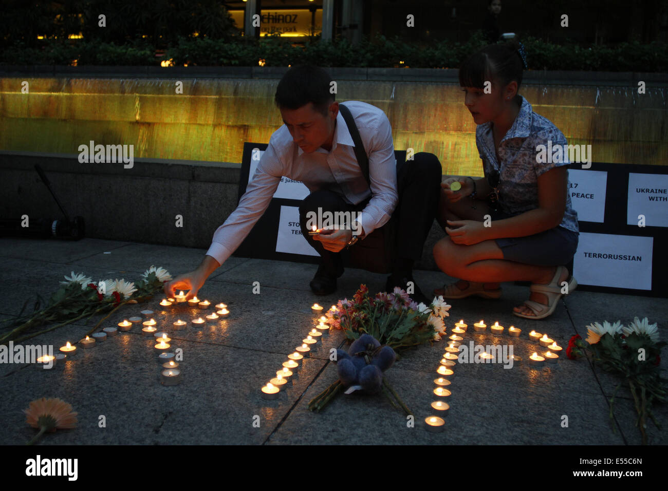 Kuala Lumpur, Malaysia. 21st July, 2014. People arranges candles during a special vigil for the passengers onboard the Malaysia Airline, MH17 in Kuala Lumpur, Malaysia, Monday, July 21, 2014. The Malaysia Airlines jetliner was carrying 298 people when it was shot down over eastern Ukraine. Credit:  Joshua Paul/NurPhoto/ZUMA Wire/Alamy Live News Stock Photo