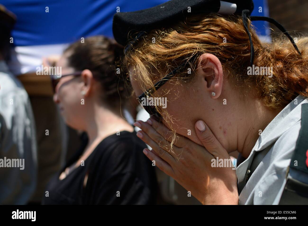 Israel. 21st July, 2014. Funeral of Maj. Tzafrir Bar-Or, 32, a commanding officer in the Golani Brigade, killed in combat in Gaza over the weekend. Holon military cemetery, Israel. Thousands took part in the funerals held Monday for the IDF soldiers who were killed in combat in Gaza over the weekend as Operation Protective Edge continued and expanded in the Strip. Credit:  Laura Chiesa/Pacific Press/Alamy Live News Stock Photo