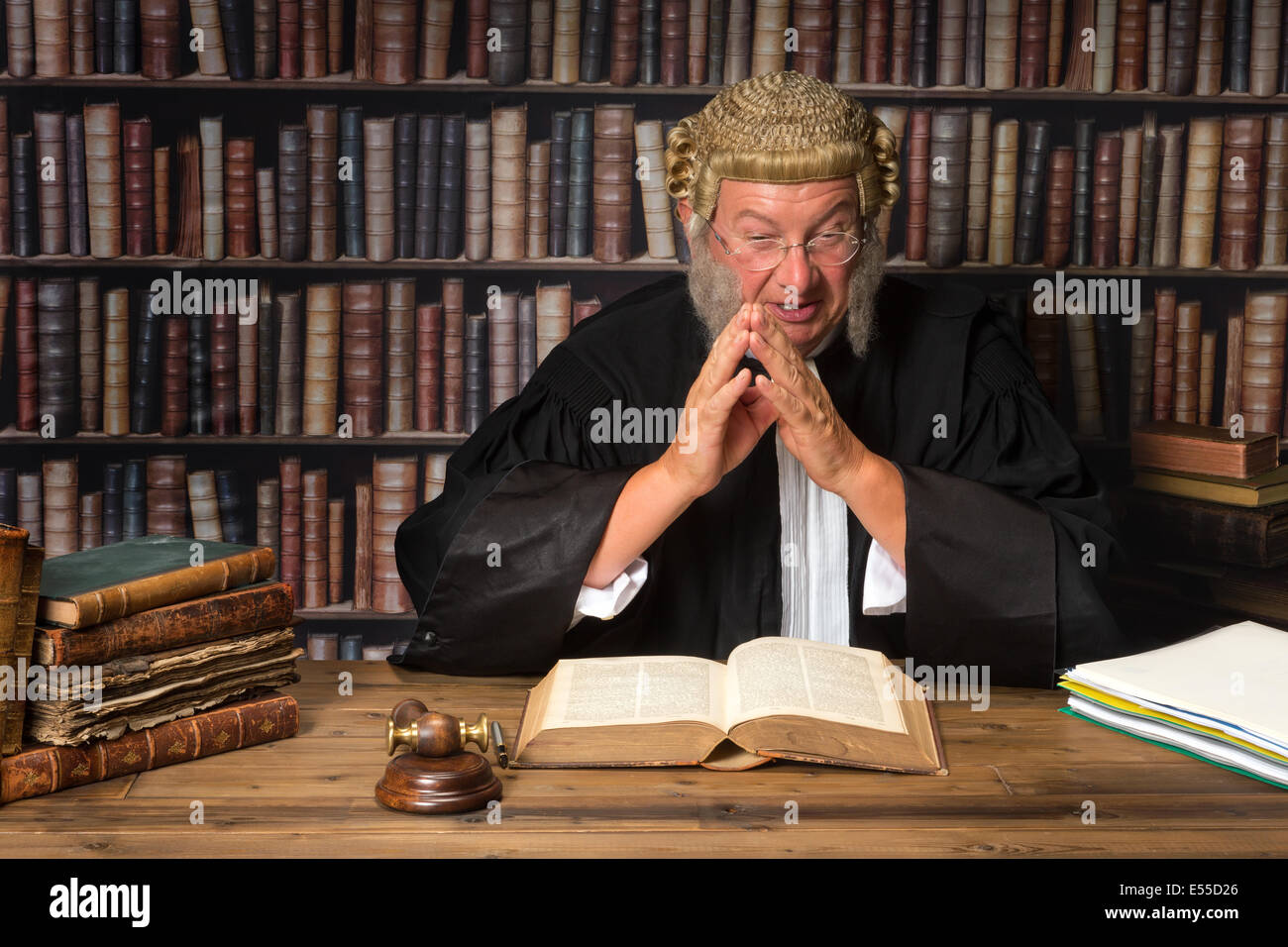 Mature judge in court consulting law books Stock Photo