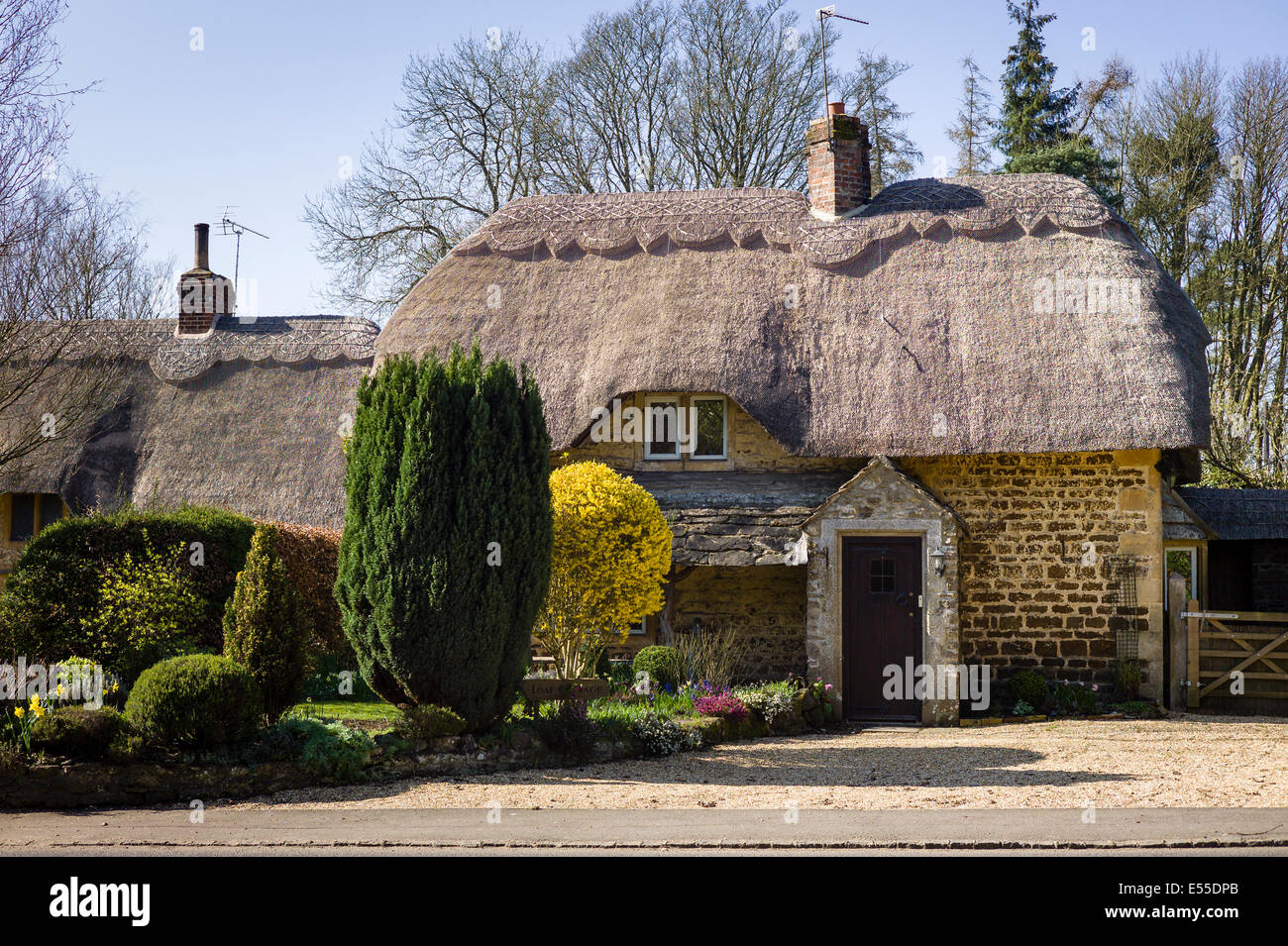 Thatched cottage and small garden in village of Sandy Lane Wiltshire UK