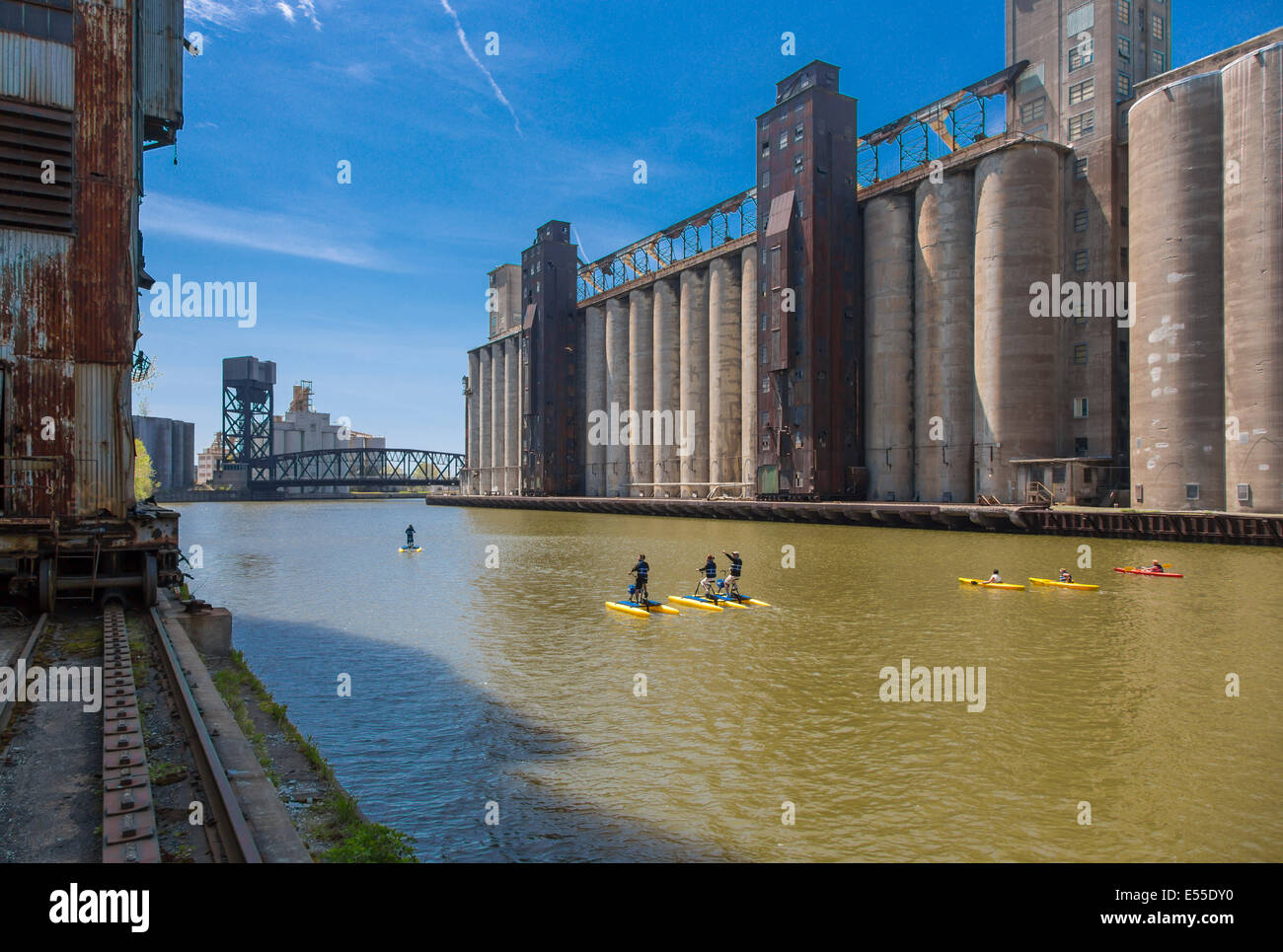Paddleboarding and kayaking in the Buffalo River along historic abandoned grain elevators on the waterfront in Buffalo, New York Stock Photo