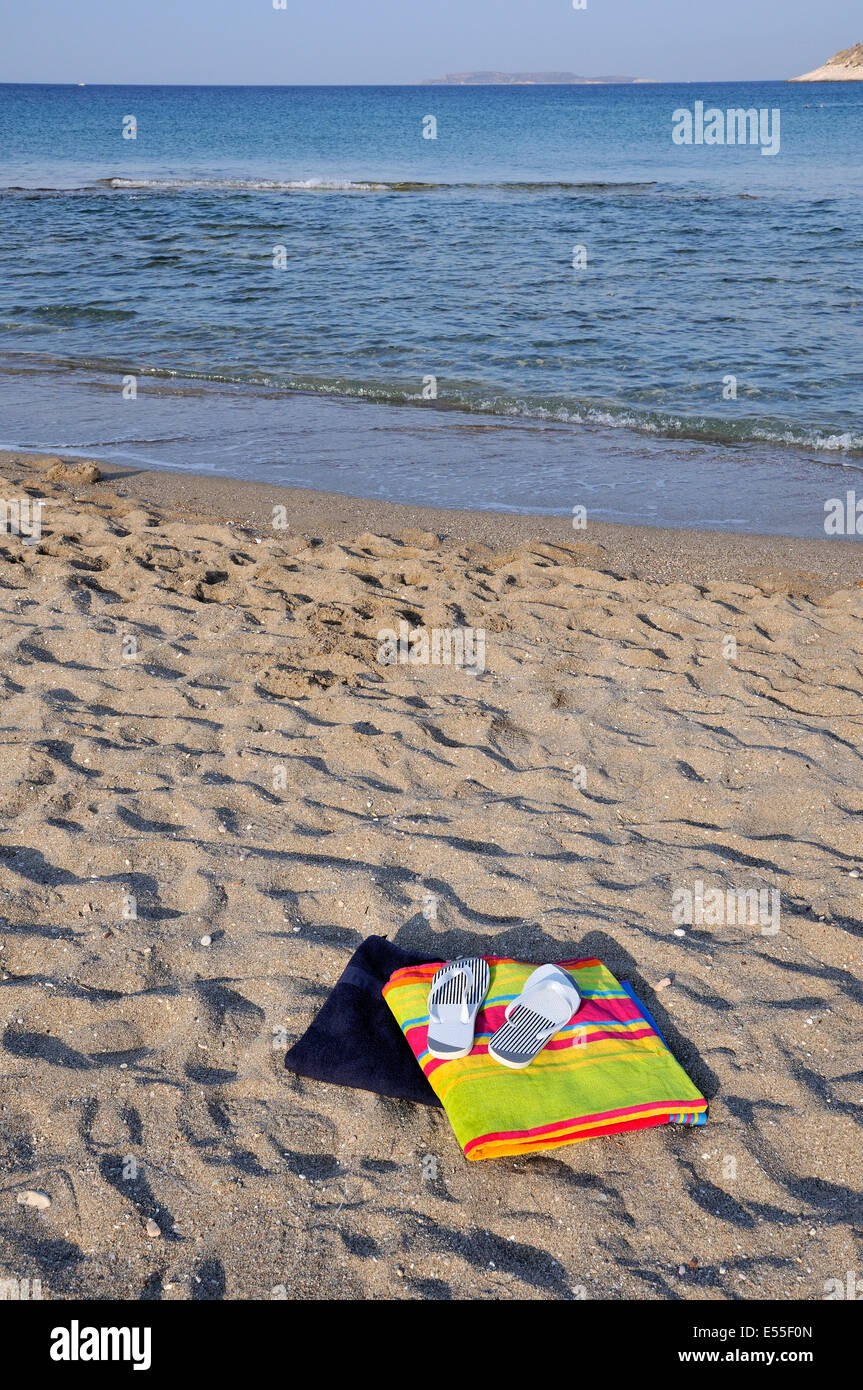 Flip flops and towels on beach Stock Photo - Alamy