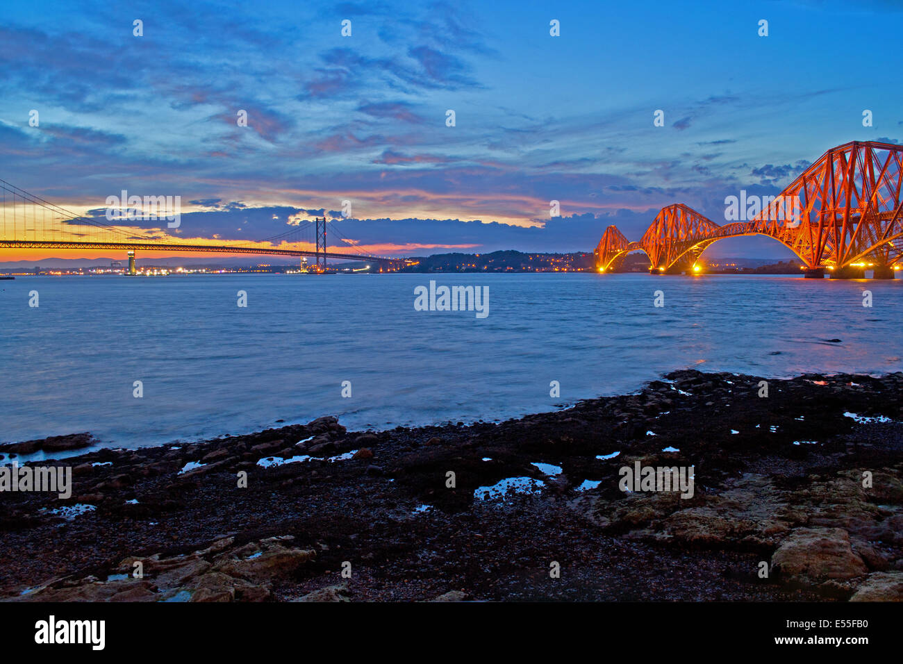 A shot of the Forth Rail and Road Bridges at dusk from South Queensferry. Stock Photo